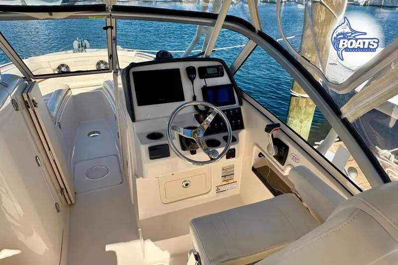 Slide: The Image of 2021 Grady-White Freedom 235 boat interior with steering wheel and control panel. - 6