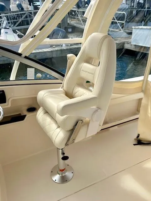 Slide: The Image of Captain's chair on 2021 Grady-White Freedom 235 boat, dockside view. - 7