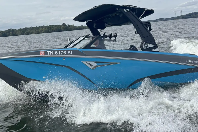 Slide: The Image of 2023 Tigé Z1 boat cruising on a lake with splashing water. - 5