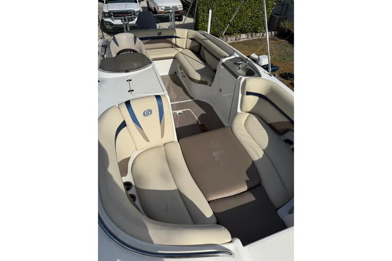 Slide: The Image of 2017 Hurricane SunDeck 2200 OB boat interior with beige seating and spacious layout. - 11
