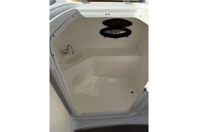 Slide: The Image of Interior of 2017 Hurricane SunDeck 2200 OB boat, featuring a compact cabin space. - 12