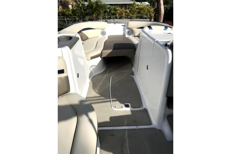 Slide: The Image of 2017 Hurricane SunDeck 2200 OB boat interior with beige seating and spacious layout. - 5