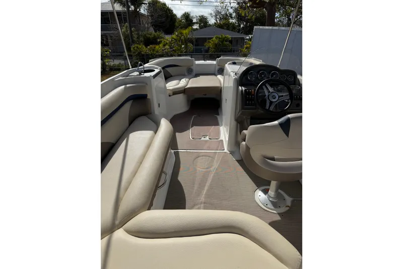 Slide: The Image of 2017 Hurricane SunDeck 2200 OB boat interior with beige seating and steering console. - 8