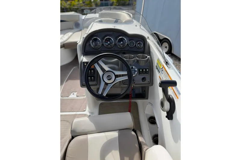 Slide: The Image of 2017 Hurricane SunDeck 2200 OB boat cockpit with steering wheel and control panel. - 9