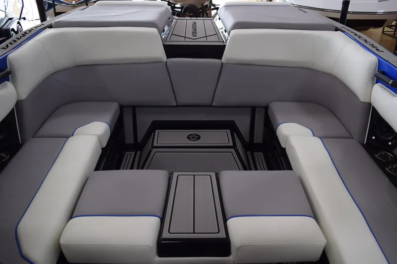 Slide: The Image of 2025 Moomba Max boat interior with gray and white cushioned seating. - 12