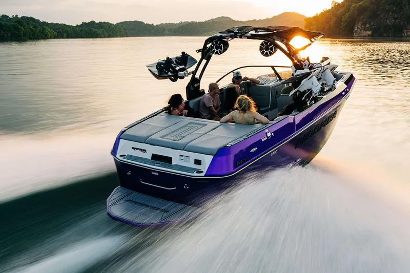 Slide: The Image of Manufacturer Provided Image: 2025 Moomba Max boat cruising on a lake at sunset with passengers enjoying the ride. - 14