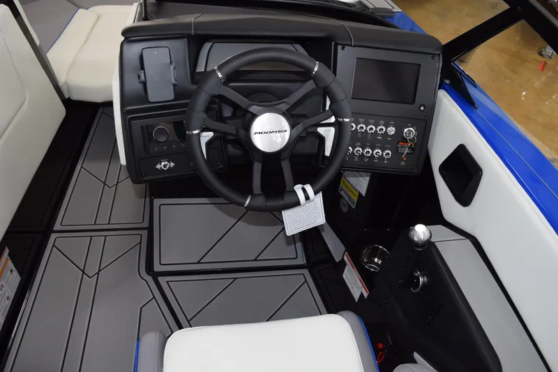 Slide: The Image of 2025 Moomba Max boat interior with steering wheel and control panel. - 5