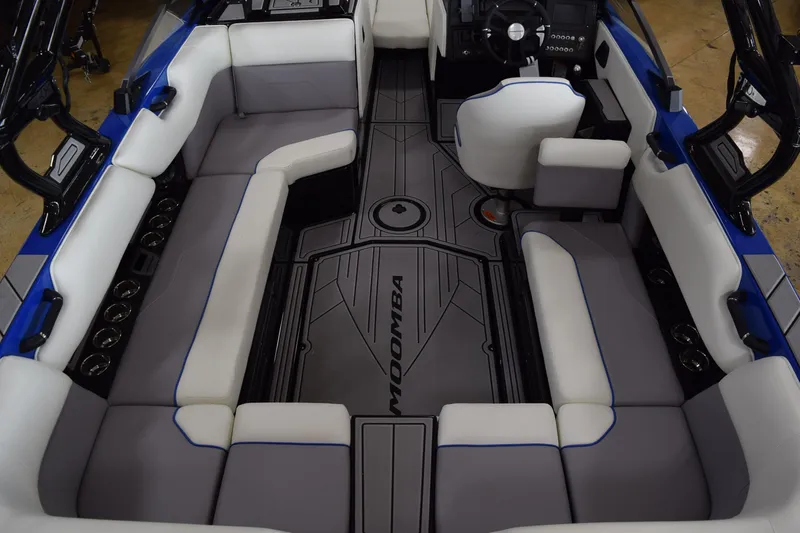 Slide: The Image of 2025 Moomba Max boat interior with gray and white seating, modern design. - 7