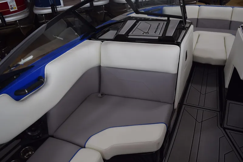 Slide: The Image of 2025 Moomba Max boat interior with gray and white seating, blue accents, and sleek design. - 8