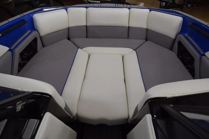 Slide: The Image of 2025 Moomba Max boat interior with gray and white cushioned seating. - 9