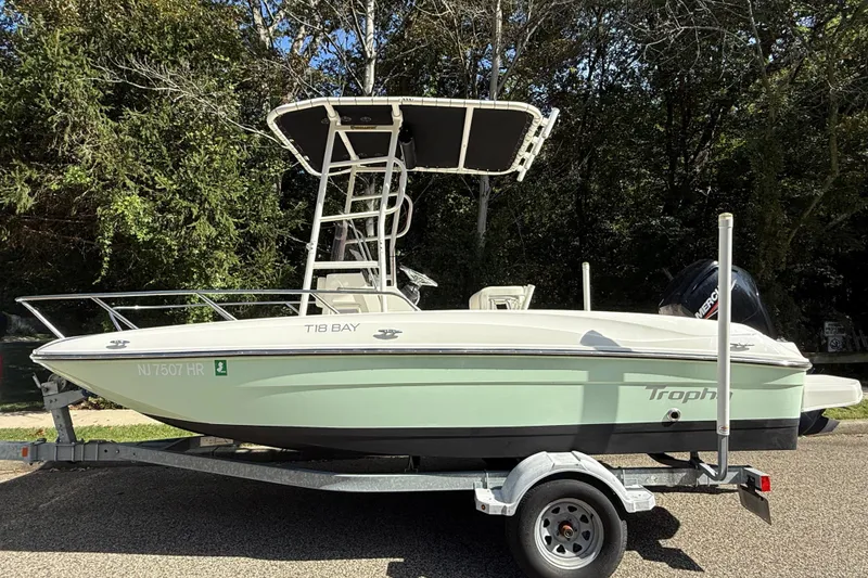 Slide: The Image of 2022 Bayliner Trophy T18Bay boat on trailer, parked outdoors. - 1