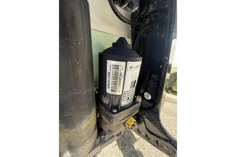 Slide: The Image of Close-up of a 2022 Bayliner Trophy T18Bay engine component with caution label. - 11