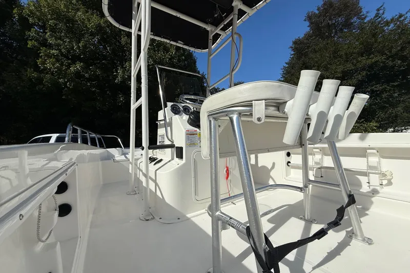 Slide: The Image of 2022 Bayliner Trophy T18Bay boat interior with rod holders and steering console. - 18