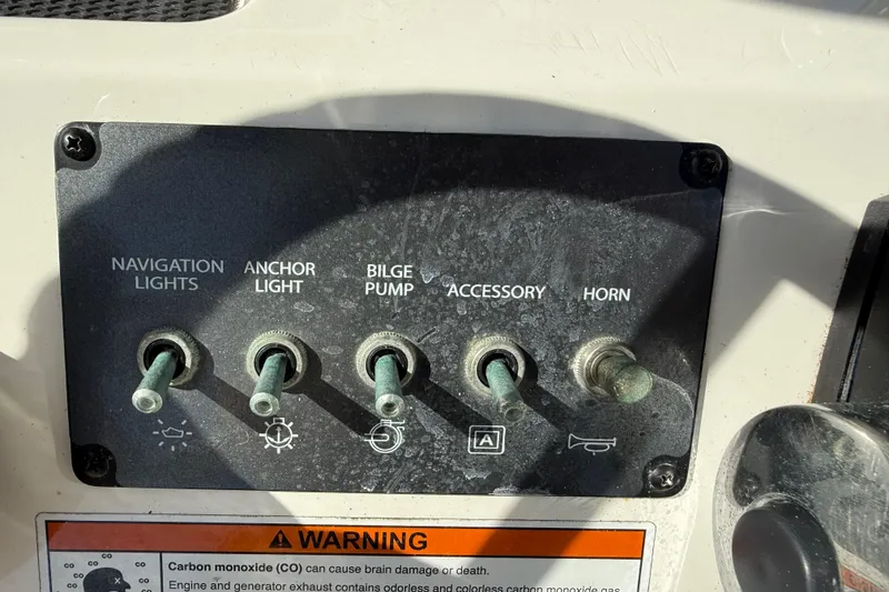 Slide: The Image of Control panel of 2022 Bayliner Trophy T18Bay with switches for lights, pump, and horn. - 19