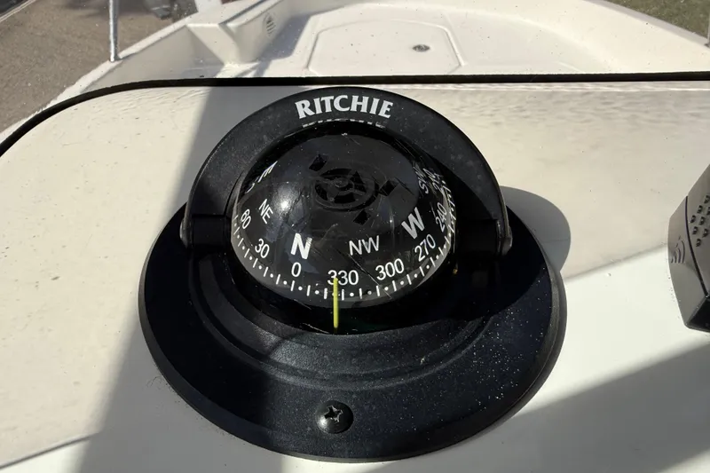 Slide: The Image of Compass on 2022 Bayliner Trophy T18Bay boat dashboard, showing navigation directions. - 22