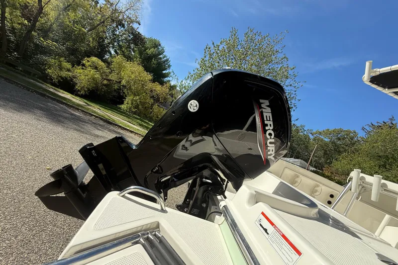 Slide: The Image of 2022 Bayliner Trophy T18Bay with Mercury outboard motor in a scenic outdoor setting. - 25