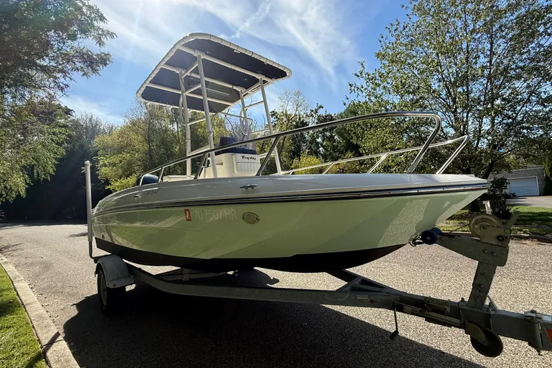 Slide: The Image of 2022 Bayliner Trophy T18Bay boat on trailer, parked on a sunny street. - 3