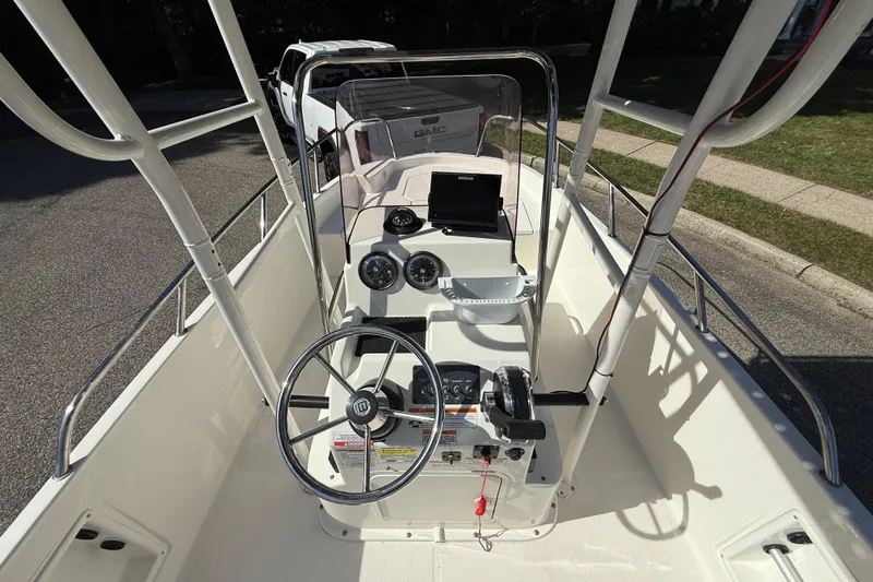 Slide: The Image of 2022 Bayliner Trophy T18Bay boat interior with steering wheel and control panel. - 4