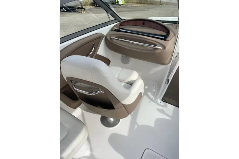 Slide: The Image of 2008 Cobalt 212 boat interior with white and brown seating and dashboard. - 4
