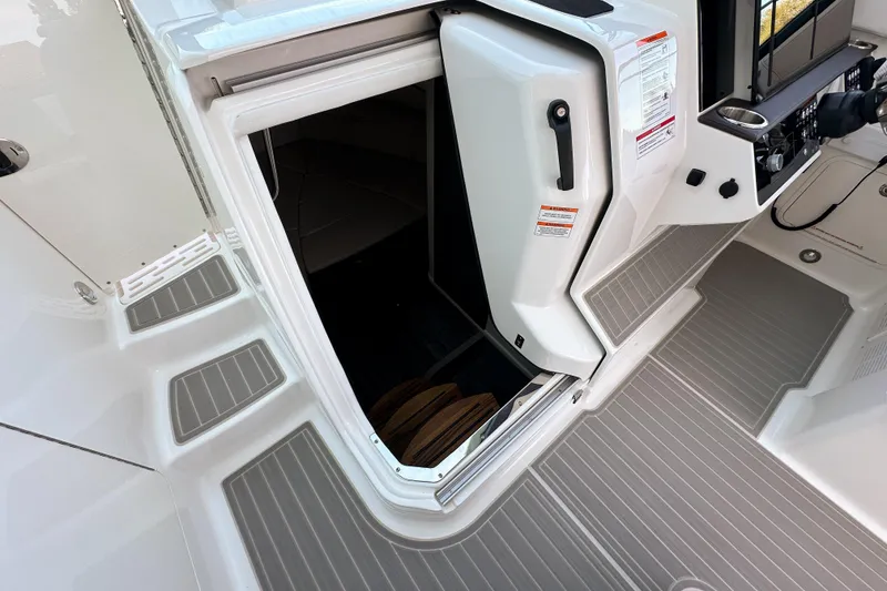 Slide: The Image of 2026 Sea Ray Sundancer 320 cabin entrance with open door and sleek interior design. - 22