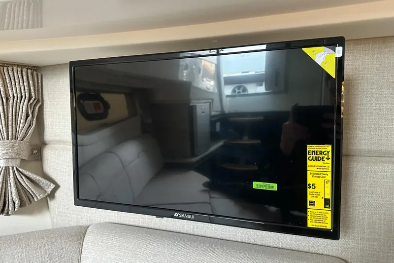 Slide: The Image of Flat-screen TV inside 2026 Sea Ray Sundancer 320 yacht, featuring energy guide label. - 24