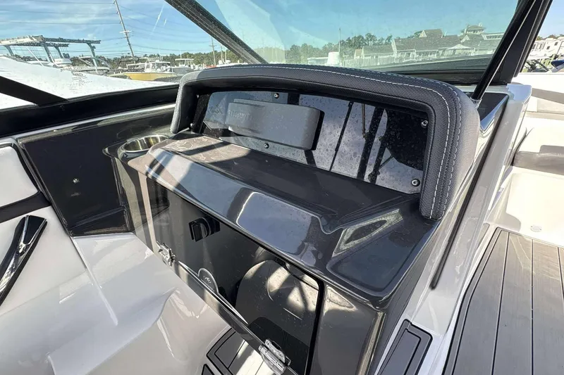 Slide: The Image of Interior of a 2020 Monterey M-225 boat, featuring sleek dashboard and cup holder. - 10