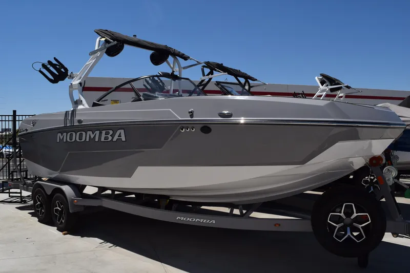 Slide: The Image of 2025 Moomba Tykon boat on trailer, sleek design, gray color, outdoor display. - 0