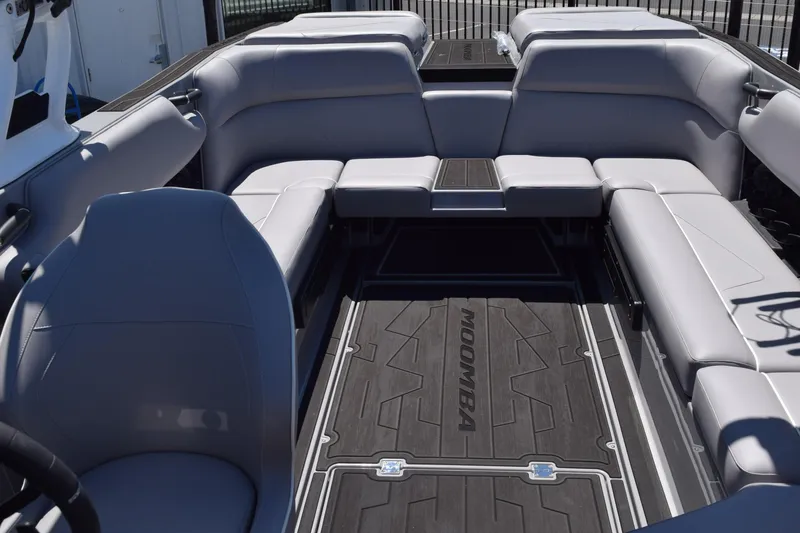 Slide: The Image of 2025 Moomba Tykon boat interior with gray seating and sleek design. - 11