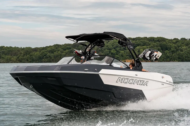Slide: The Image of Manufacturer Provided Image: 2025 Moomba Tykon boat cruising on a lake with lush green shoreline. - 16
