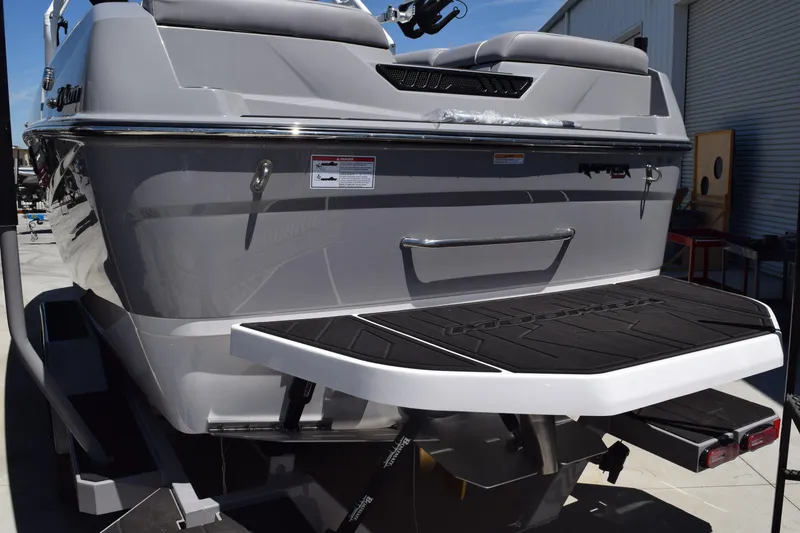 Slide: The Image of 2025 Moomba Tykon boat rear view with swim platform and sleek design. - 3