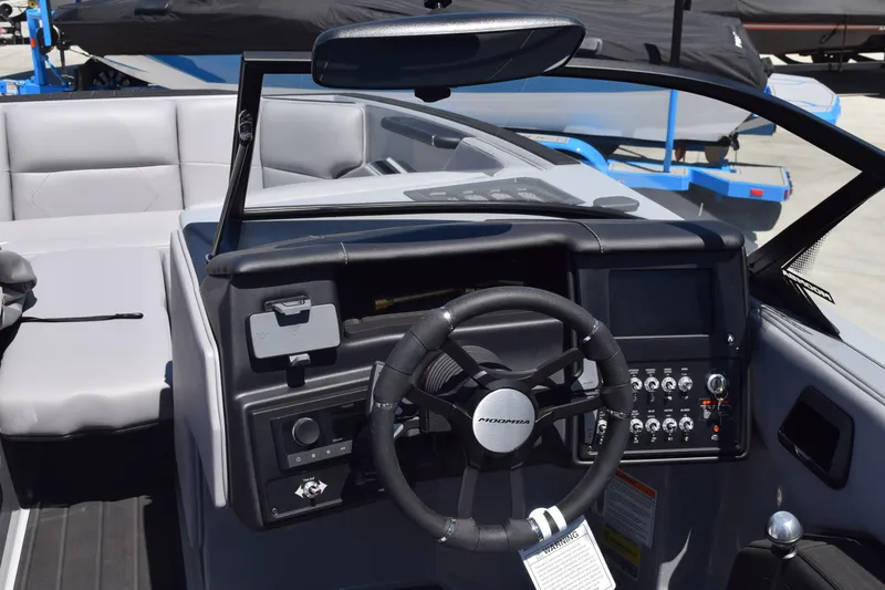 Slide: The Image of 2025 Moomba Tykon boat dashboard with steering wheel and control panel. - 5