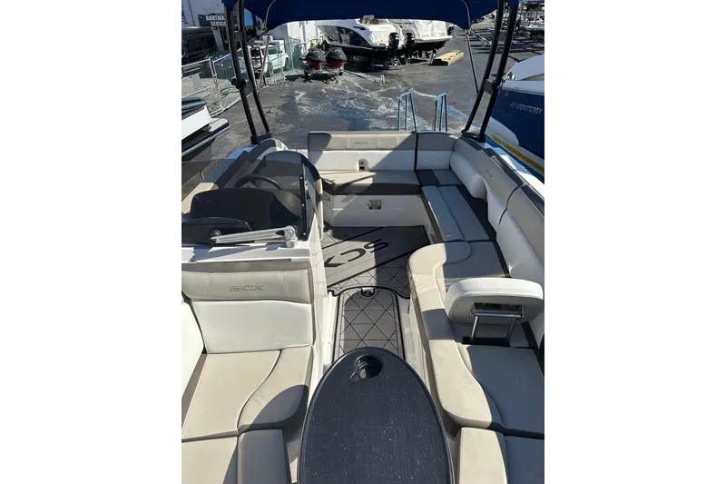 Slide: The Image of 2019 Starcraft Crossover 231 SCX IO SURF boat interior with seating and canopy. - 10