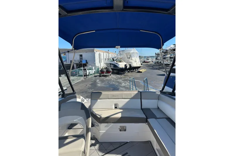 Slide: The Image of 2019 Starcraft Crossover 231 SCX IO SURF boat interior with blue canopy. - 4