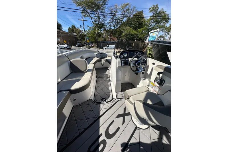 Slide: The Image of 2019 Starcraft Crossover 231 SCX IO SURF boat interior with seating and steering console. - 5