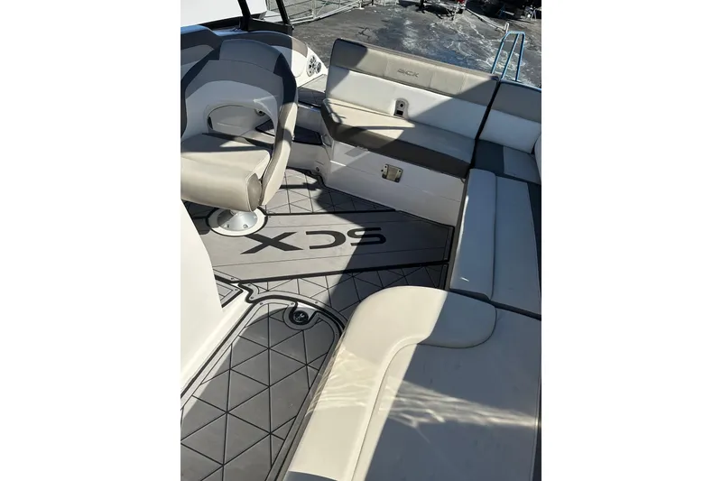 Slide: The Image of 2019 Starcraft Crossover 231 SCX IO SURF boat interior with cushioned seating and stylish flooring. - 7