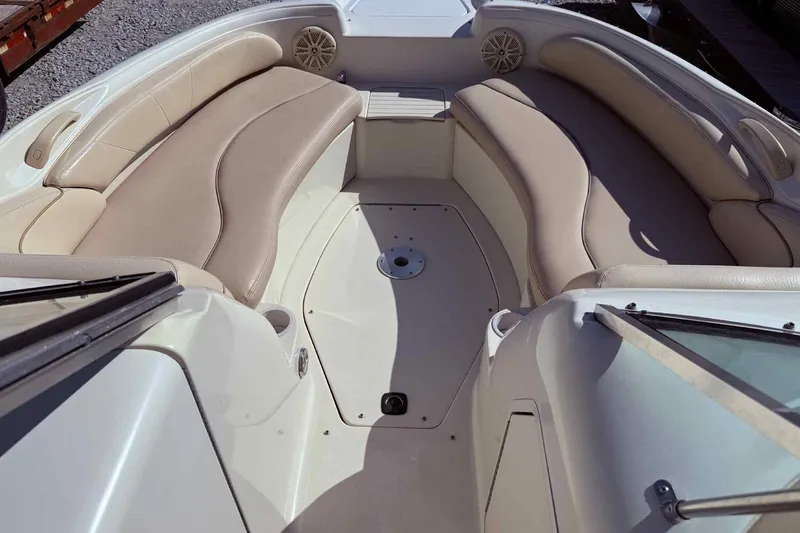 Slide: The Image of 2000 Sea Ray 210 Sundeck interior with beige seating and spacious layout. - 15