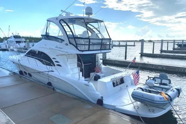 The Image of 2007 Sea Ray 52 Sedan Bridge yacht docked at marina with inflatable boat. - 0