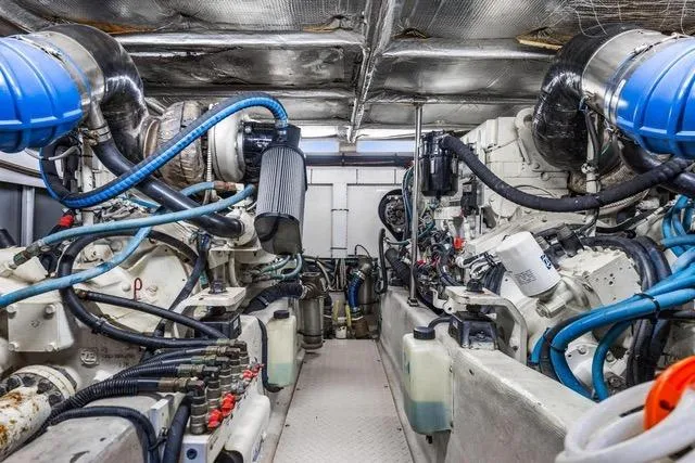Slide: The Image of Engine room of 2007 Sea Ray 52 Sedan Bridge with complex machinery and piping. - 10