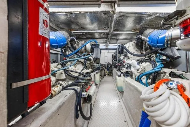 Slide: The Image of Engine room of a 2007 Sea Ray 52 Sedan Bridge yacht, featuring dual engines and safety equipment. - 11