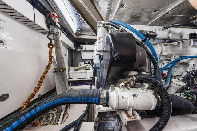 Slide: The Image of Engine room of 2007 Sea Ray 52 Sedan Bridge with visible machinery and cables. - 14