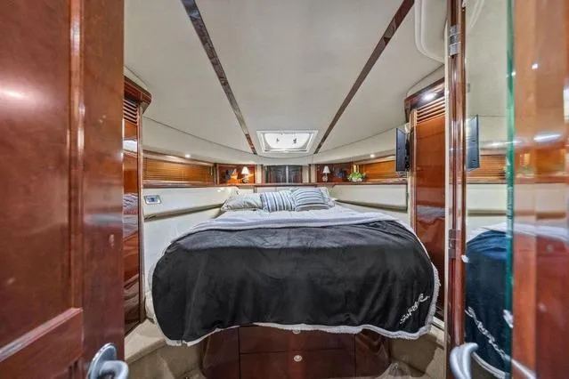 Slide: The Image of Luxurious 2007 Sea Ray 52 Sedan Bridge yacht bedroom interior with elegant wood finishes. - 27