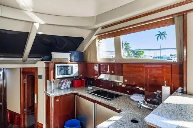Slide: The Image of Luxurious 2007 Sea Ray 52 Sedan Bridge yacht kitchen with modern amenities and sleek design. - 34