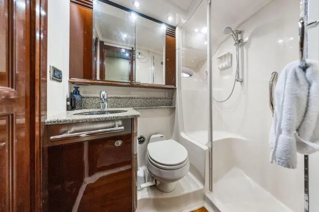 Slide: The Image of Luxurious bathroom in 2007 Sea Ray 52 Sedan Bridge yacht with modern fixtures and wood accents. - 36