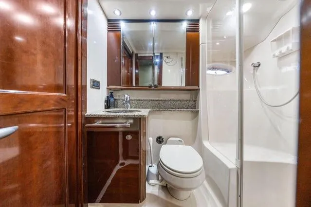 Slide: The Image of Luxurious bathroom in 2007 Sea Ray 52 Sedan Bridge yacht with wood accents and modern fixtures. - 38