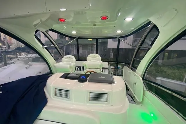 Slide: The Image of 2007 Sea Ray 52 Sedan Bridge interior with helm, seating, and panoramic windows. - 41