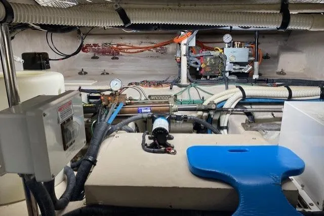 Slide: The Image of Engine room of a 2007 Sea Ray 52 Sedan Bridge with visible gauges and piping. - 44