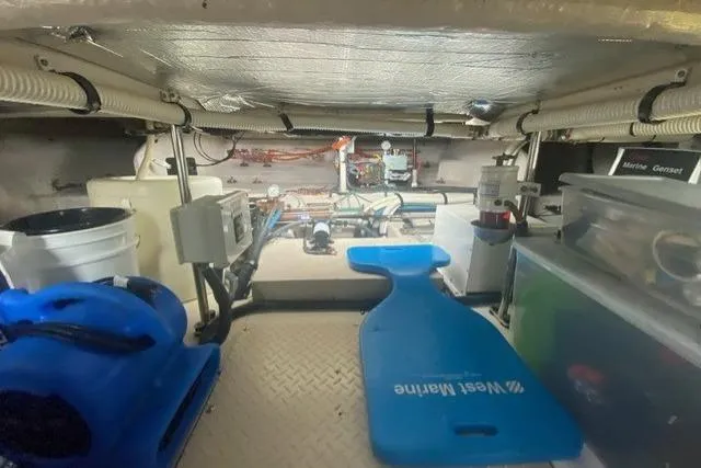 Slide: The Image of Engine room of 2007 Sea Ray 52 Sedan Bridge with equipment and storage. - 45