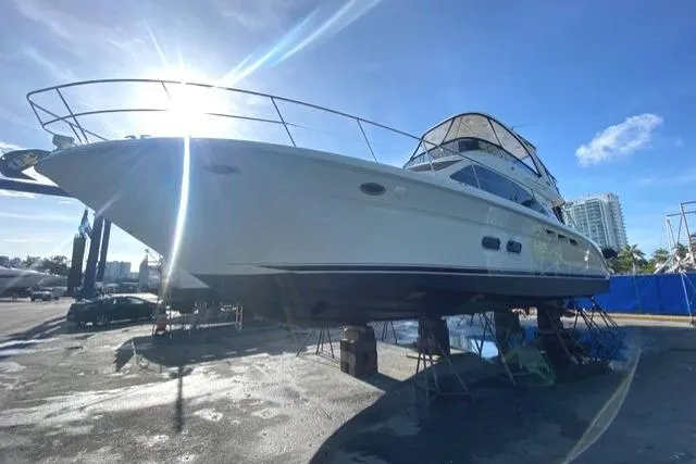 Slide: The Image of 2007 Sea Ray 52 Sedan Bridge yacht on dry dock under bright sunlight. - 5