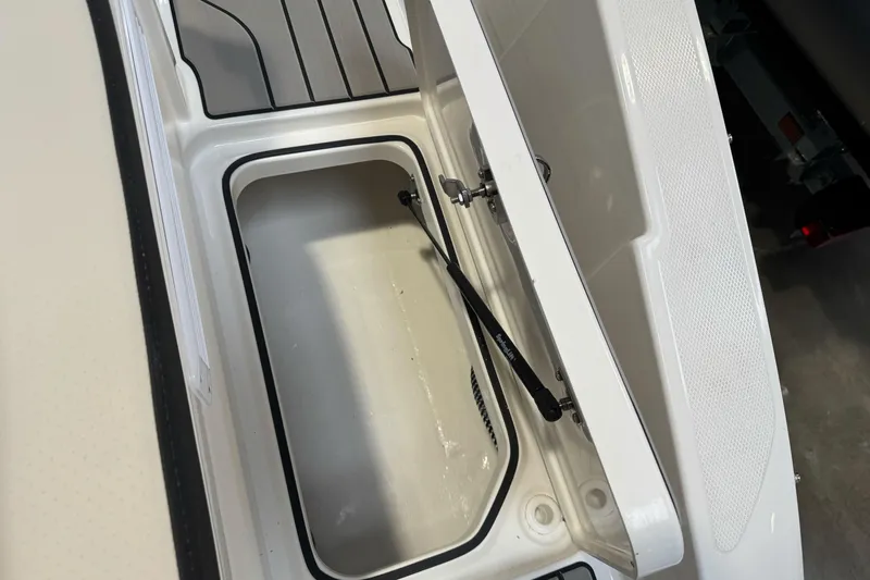Slide: The Image of Open storage compartment on 2026 Sea Ray SPX 210 boat, showcasing interior space. - 11
