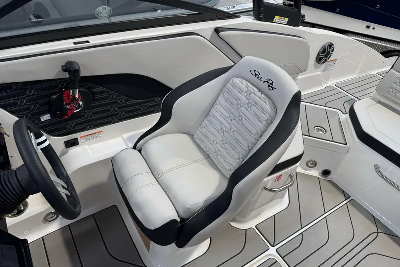 Slide: The Image of 2026 Sea Ray SPX 210 boat interior with sleek white seating and modern dashboard. - 16